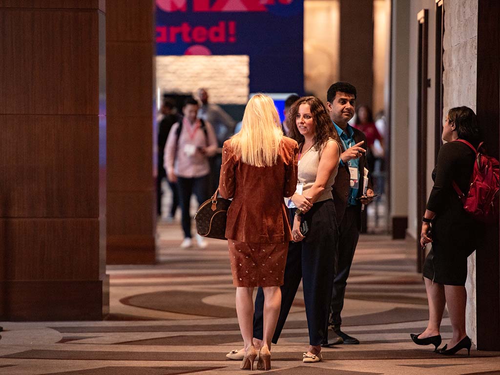 GTM attendees chatting in the exhibition hall.